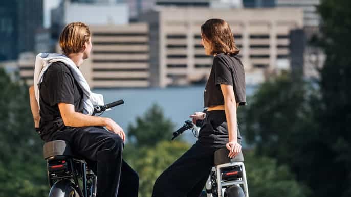 2 persons chat beside their bike photo